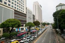 Vehicles travel along office and hotel area of Sule Road in central Yangon. Photo: Sai Aung Mai/AFP