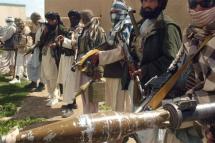 Taliban militants in a line holding guns and explosives. Photo: AFP