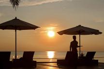 Hotel waiter serves during the setting sun on Ngwe Saung beach, also called Silver Sands, near Ngwe Saung township, some 260 km from Yangon in Pathein province, Ayeyarwaddy Devision, Myanmar. Photo: EPA