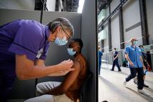 A member of the public receives the Pfizer-BioNTech Covid-19 vaccine in the Turbine Hall at a temporary Covid-19 vaccine centre at the Tate Modern in central London. Photo: AFP