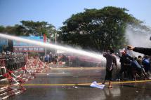 Police fire water cannon at demonstrators during a protest against the military coup, in Naypyitaw, Myanmar, 09 February 2021. Photo: EPA