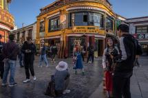 People pose for photos in an alley near the Jokhang Temple in Lhasa, Tibet Autonomous Region, China. Photo: EPA