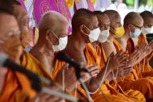 Monks gesture during an event ahead of the Buddhist festival Asanha Bucha at Bang Nara temple in the southern Thai province of Narathiwat on July 8, 2022. Photo: AFP