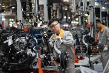 A Chinese employee working on a production line of automobiles at a factory in Changchun. Photo: AFP