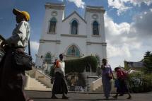 Catholics from Myanmar walk in front of St. Anthony Church in Yangon. Photo: AFP