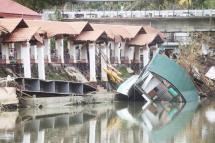 A floating restaurant lays on its side in Loboc town, Bohol province on December 21, 2021 after it was swept away at the height of super Typhoon Rai that devastated the province. (Photo by Cheryl BALDICANTOS / AFP)