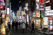 Pedestrians walk on a street in the Shinjuku area of Tokyo on Tuesday. | AFP-JIJI