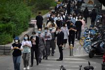 People wait in line to be tested for the Covid-19 coronavirus at a swab collection site in Beijing on April 25, 2022. Photo: AFP