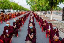 Monks line up to receive alms during a military junta-organised gathering to mark the Buddha's Birthday near the former royal palace in Mandalay on May 14, 2022. Photo: AFP