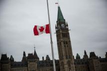 A flag next to the Canadian Parliament Building is flown at half staff one day after Cpl. Nathan Cirillo of the Canadian Army Reserves was killed while standing guard in front of the National War Memorial by a lone gunman, on October 23, 2014 in Ottawa, Canada. Photo: AFP