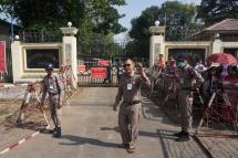 Prison officials stand guard as they prepare for the release of prisoners outside of the Insein Prison in Yangon on April 17. Photo: AFP