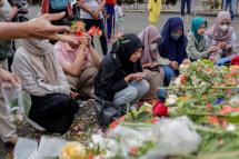 Relatives gather to pay condolences for the victims of a riot and stampede outside Kanjuruhan Stadium in Malang, East Java, Indonesia. Photo: EPA