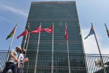  In this file photo taken on May 20, 2021 people walk past flags outside the United Nations headquarters in New York City.  Photo: AFP