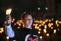 Xiong Yan, one of the 21 most-wanted Tiananmen Square protesters holds a candle. Photo: EPA