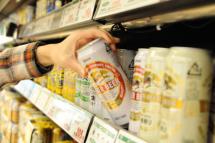 A shopper picks up a can of Kirin beer at a supermarket in Tokyo, Japan. Photo: EPA