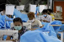  Workers make disposable surgical gown at a garment factory in Yangon, Myanmar. Photo: EPA