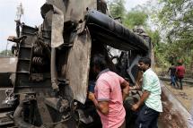 People look for their missing relatives near a damaged train compartment after a train accident at Odisha Balasore, India 04 June 2023. Photo: EPA